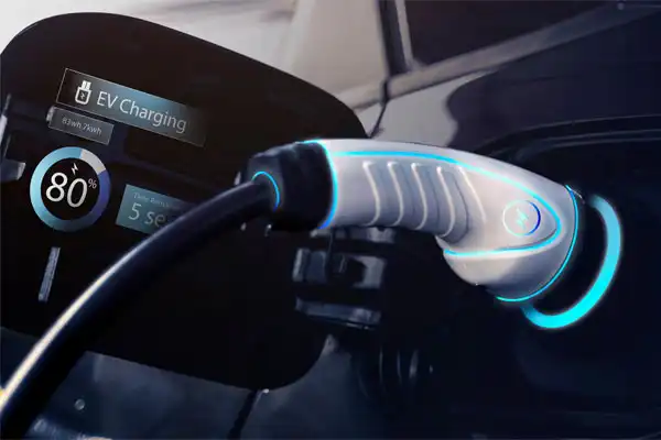 Close-up of an electric vehicle charging port with a charger plugged in. The display shows charging at 80% with an estimated 5 seconds remaining, demonstrating the efficiency of modern car charging installations.