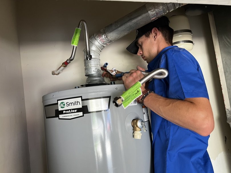 Norman Air Employee Fixing Repairing Water Heater